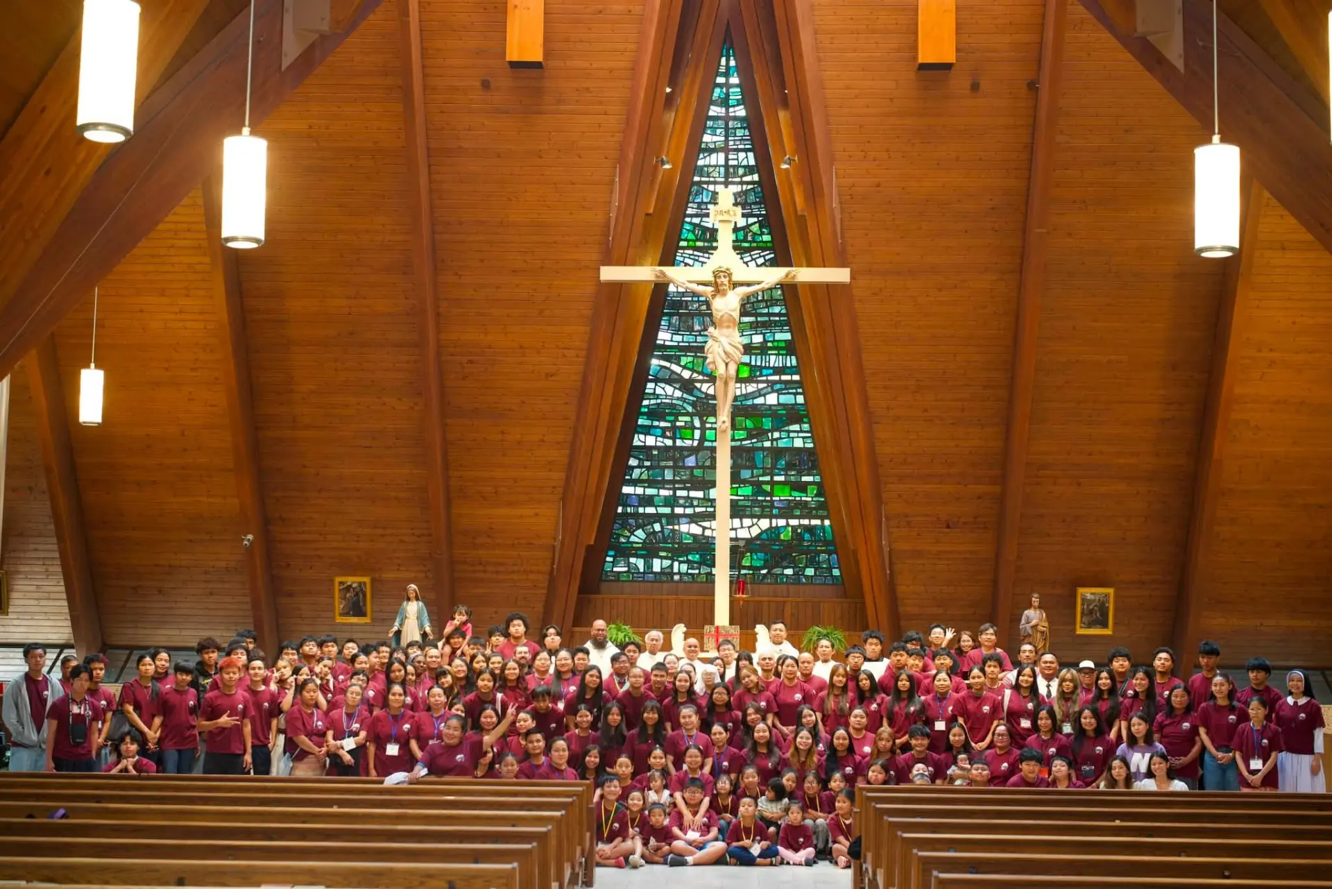 KACC community gathered together in front of the crucifix in church